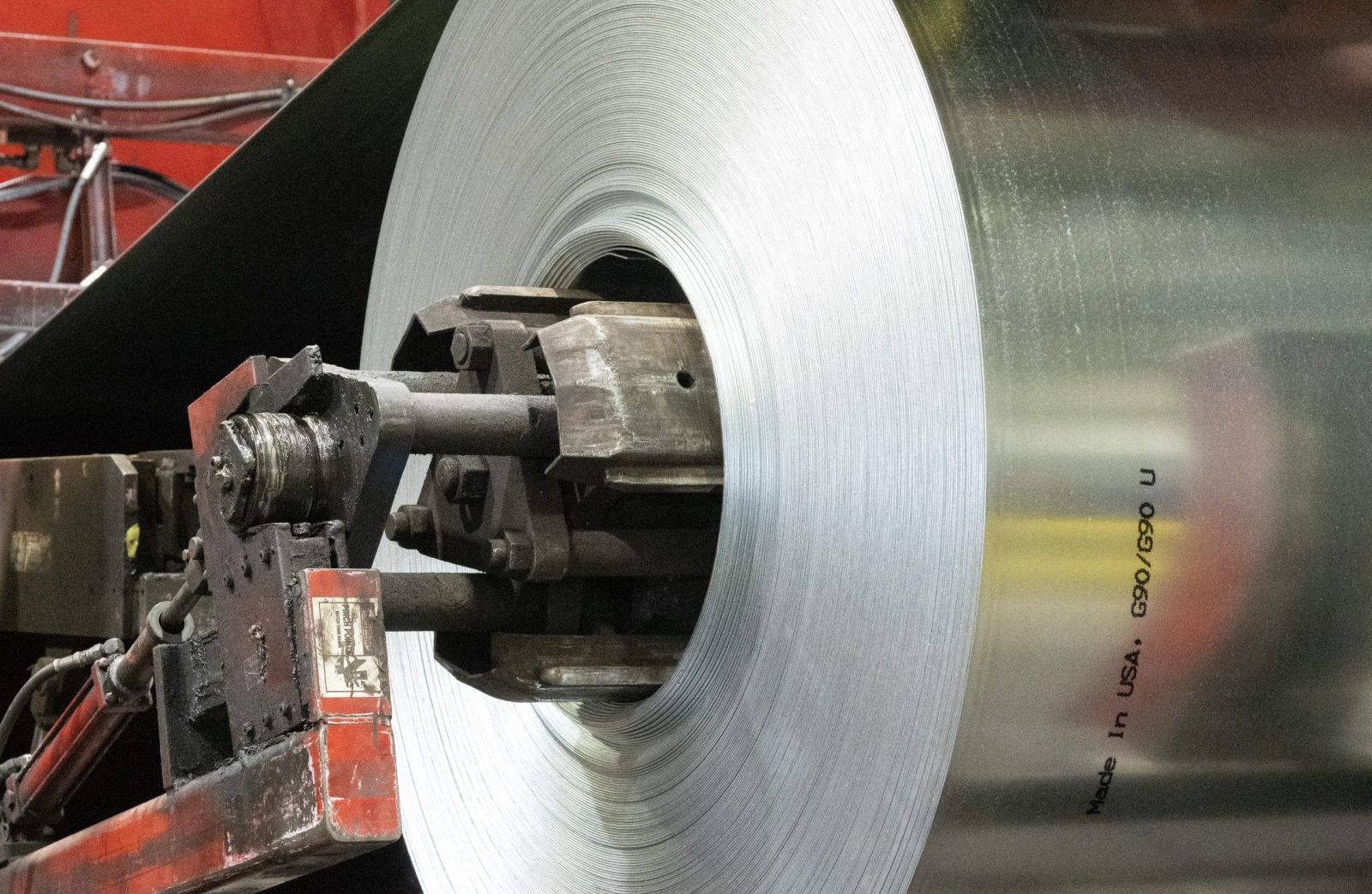 Cold Rolled Steel Coil in Processing Close-up of a large coil of cold rolled steel being processed on industrial machinery, featuring a 'Made in USA' marking.
